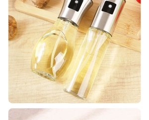 Dual glass oil sprayers on wood board with fresh cooking ingredients detail