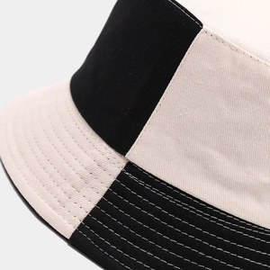 Detailed close-up of high-quality stitching on a two-tone cotton bucket hat brim
