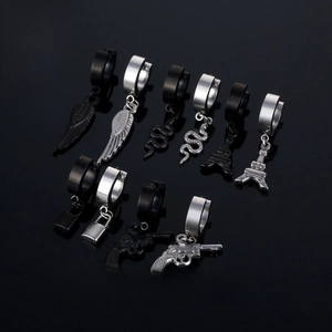 Detail of stainless steel ear clips with diverse charms like wings, snake, and lock