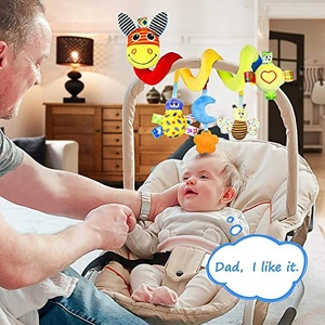 Spiral baby plush toy with zebra and bee hanging from a stroller handle in a family setting