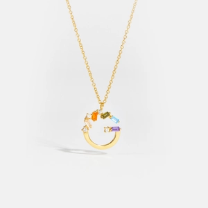 Close-up of letter G pendant with multi-color baguette gemstones and gold chain