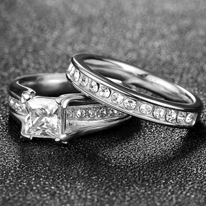 Macro view of princess cut cubic zirconia wedding ring set with pave setting on black stand