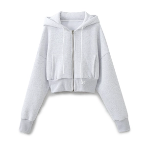 Detail of light gray cropped zip-up hoodie featuring a drawstring hood and front pockets