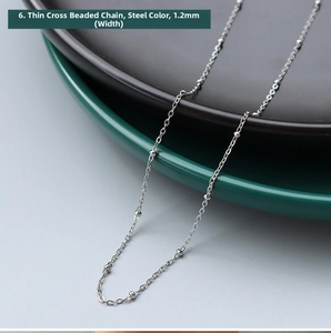 Macro shot of 1.2mm steel-toned stainless steel cross bead chain necklace detail