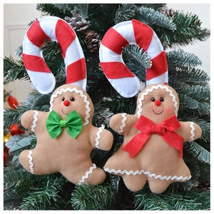 Close-up of gingerbread man felt ornaments hanging on a Christmas tree branch