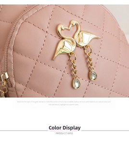 Detail of pink quilted leather mini backpack with golden twin swan hardware and crystals