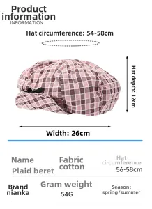 Detail of pink plaid denim beret with black bow accent and cotton knit texture