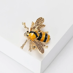 Detailed close-up of yellow enamel bee brooch with sparkling crystal inlaid wings