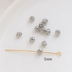Detailed view of 5mm hollow gold-plated spherical beads for DIY jewelry making