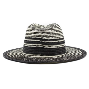 Close-up of black and beige striped woven texture on a classic fedora sun hat