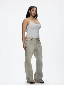 Gray slim fit U-neck tank top paired with light blue vintage wash denim jeans
