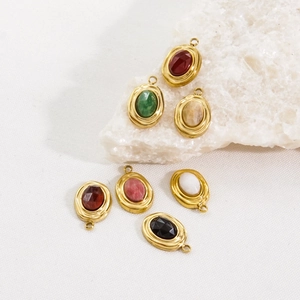 Detail of vintage 14K gold-plated oval gemstone pendants in seven assorted colors