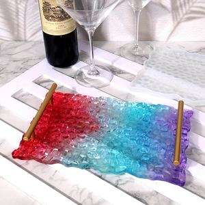 DIY resin tray detail with colorful honeycomb texture and gold metal handles on a white grid