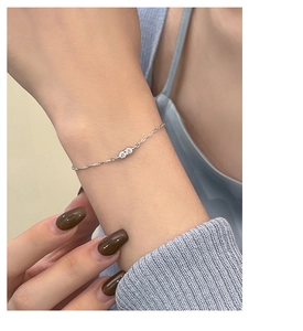 Close-up of s925 silver water wave chain bracelet with sparkling round cubic zirconia