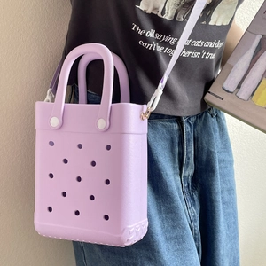 Close-up of purple EVA beach bag with holes featuring white adjustable shoulder strap