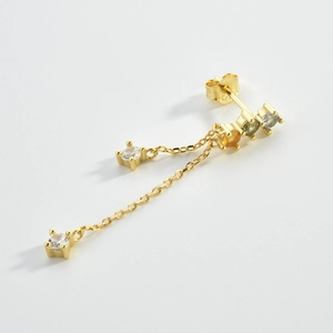 Detailed macro of gold S925 silver fringe earrings with colorful zircon stones
