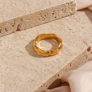 Detailed close-up of a 18K gold plated stainless steel ring with water ripple texture