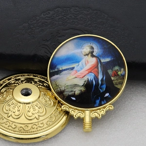Detailed close-up of a golden metal religious ornament featuring a Jesus prayer icon