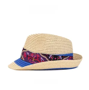 Side view of woven fedora sun hat with ethnic paisley ribbon and blue edge trim