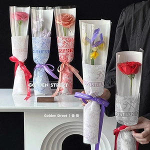 Detail of floral bouquet wrap featuring luxury animal print tissue paper and branded ribbon