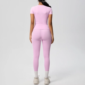 Rear view of a pink high-waist fitness set with short-sleeve shirt and yoga leggings