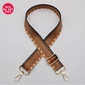 Close-up of 38mm wide woven bag strap with orange geometric pattern and gold buckles