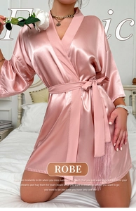 Detailed view of pink satin robe featuring elegant silk texture and fringed tie belt