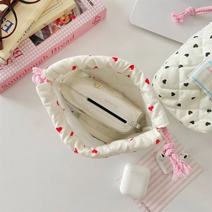 Quilted drawstring pouch with red heart pattern storage for instant camera and accessories