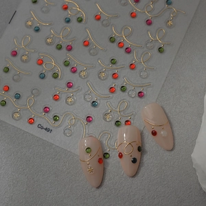Detailed 5D embossed Christmas nail stickers with colorful rhinestones and gold curves