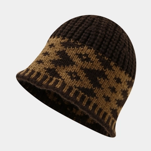 Detail of chunky knit bucket hat showing vintage geometric pattern and thick wool texture