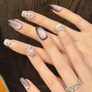 Dark purple cat-eye butterfly press-on nails in long coffin shape with glitter accents