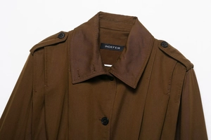 Close-up of brown long coat showing lapel collar, epaulettes and twill fabric texture