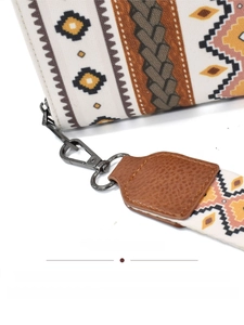 Detail of bohemian canvas clutch featuring bronze-toned hardware and durable fabric