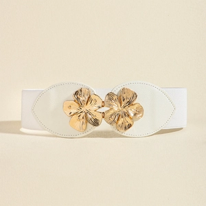 Detail of white elastic waist belt featuring a decorative golden peach blossom buckle