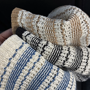 Striped knit bucket hat set in blue, black, and brown with crochet hollow design