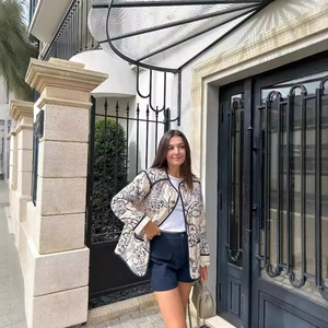 Women's black and white printed cotton jacket with long sleeves in a stylish outdoor setting