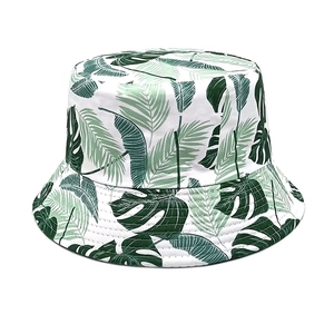 Detailed close-up of tropical palm leaf print on white canvas bucket hat texture