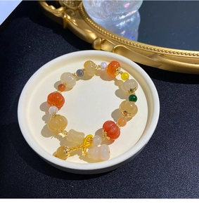 Detailed macro view of colorful pumpkin shaped bodhi seed beads with golden accents
