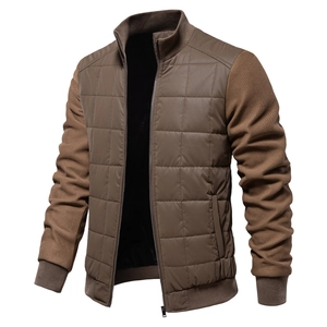 Detail of men's brown jacket showing quilted body fabric and heavy knit sleeve texture