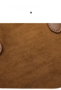 Macro view of brown suede texture with detailed stitching on the Boston bag