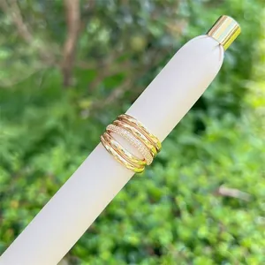 Macro detail of layered 18K gold plated mesh rings with sparkling micro-pave zircons