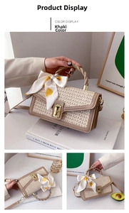 Detail of straw woven bag featuring a metal twist lock and a yellow heart scarf bow