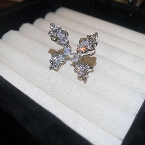 Silver butterfly open ring with sparkling cubic zirconia on white velvet background