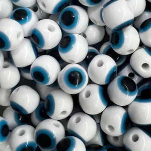 Flat lay of resin Evil Eye beads with blue striped patterns for DIY jewelry making