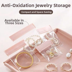 Three sizes of pink EVA jewelry seal bags storing rings and necklaces in a box