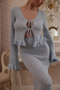 Detail of light blue hollow knit fabric showing delicate pointelle texture and tie-up design