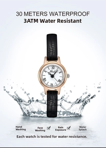 Detail of Gedi vintage watch with leather strap splashing in water for waterproof feature