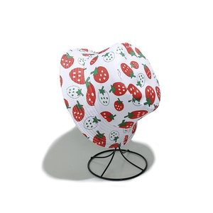 Detailed close-up of white bucket hat featuring vibrant strawberry patterns on a display stand