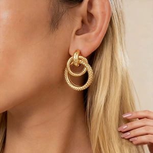 Textured gold interlocking geometric hoop earrings for women with a vintage metallic finish