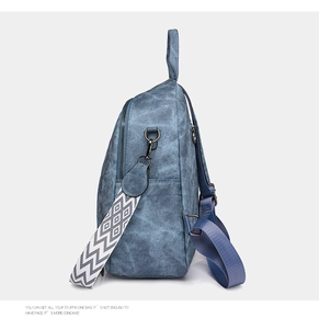 Detail of blue vintage soft PU leather backpack with decorative geometric strap